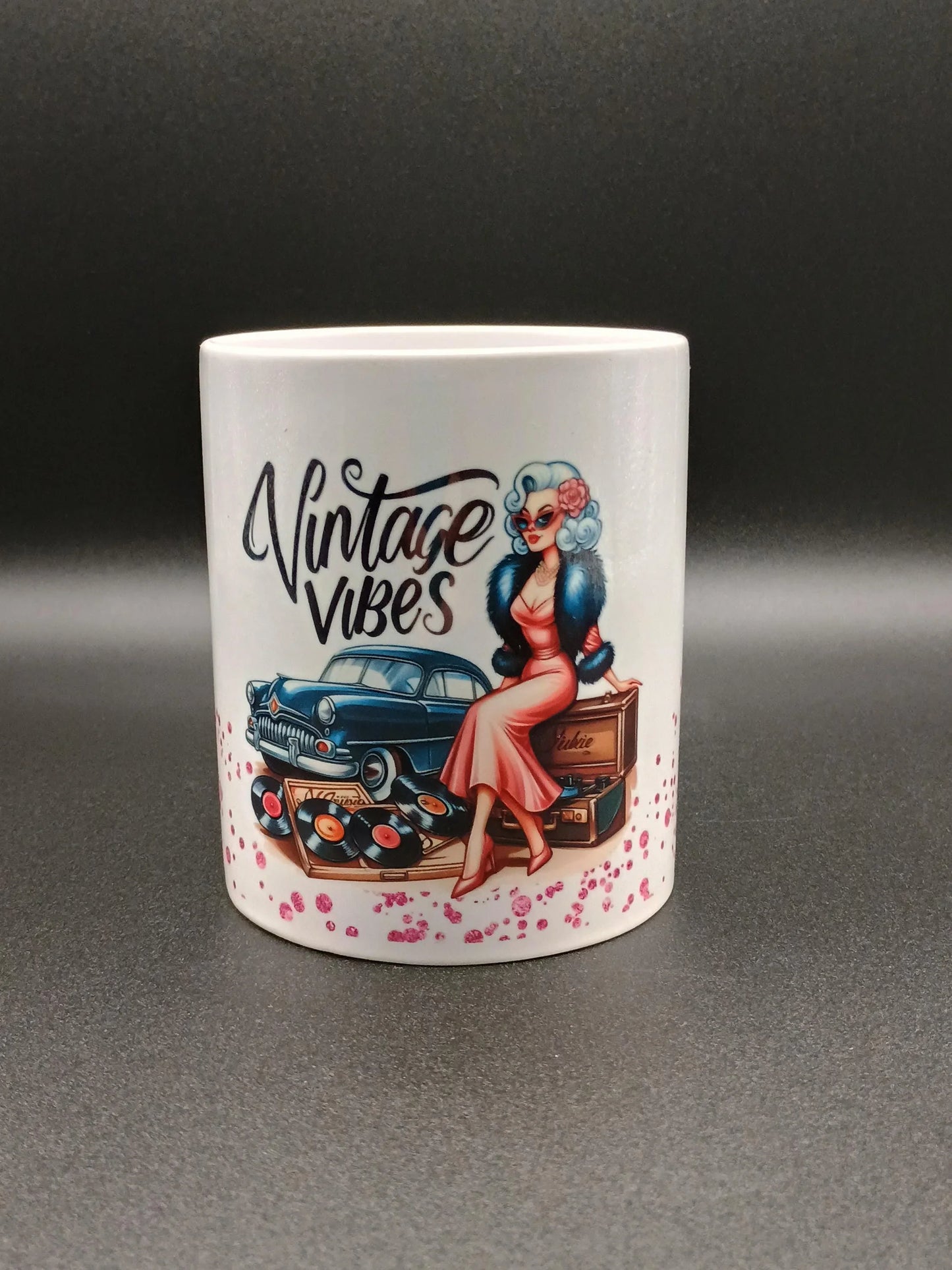 White mug with retro design featuring a vintage car, woman in pink dress, vinyl records, and text Vintage Vibes