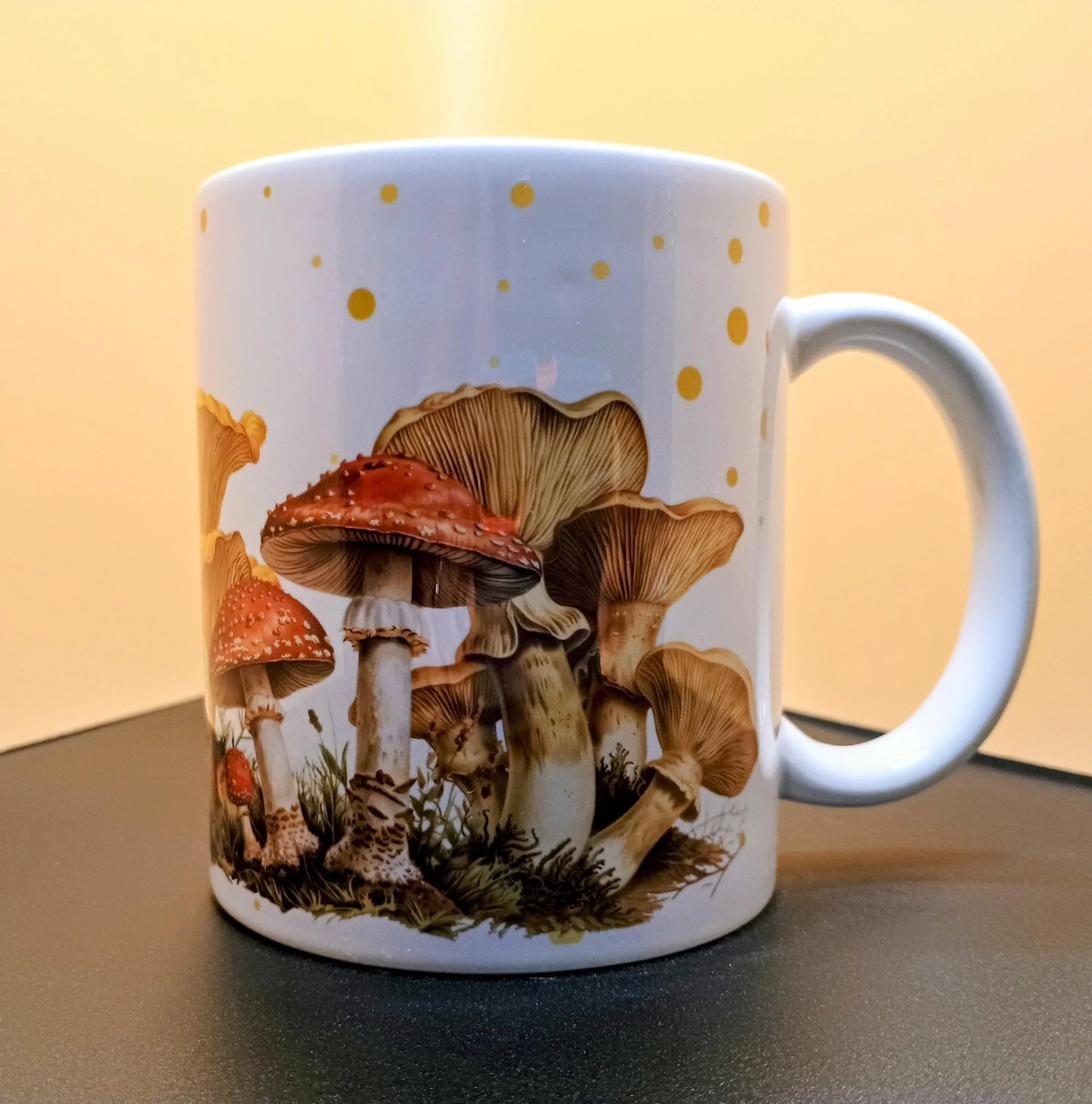 White ceramic mug with detailed mushroom illustration and yellow polka dots on side