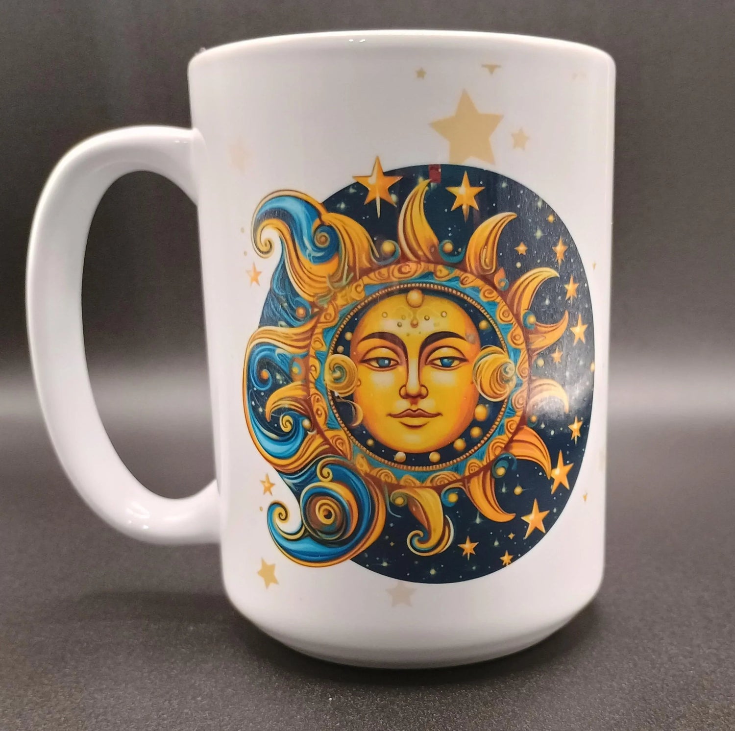 White ceramic mug with colorful sun and moon celestial face design and stars