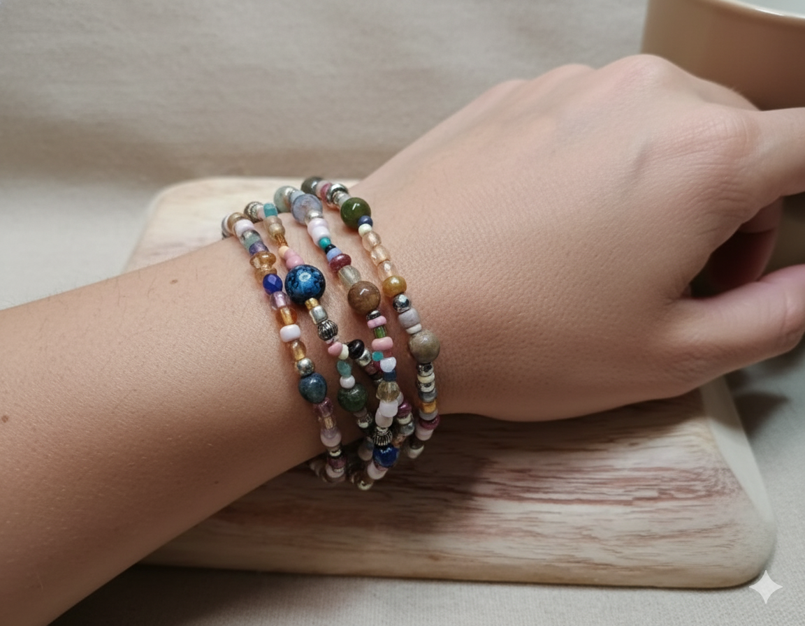 Close-up of a wrist wearing a multi-strand colorful beaded bracelet on a wooden surface